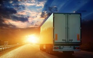 truck driving into sunset - transportation risk management